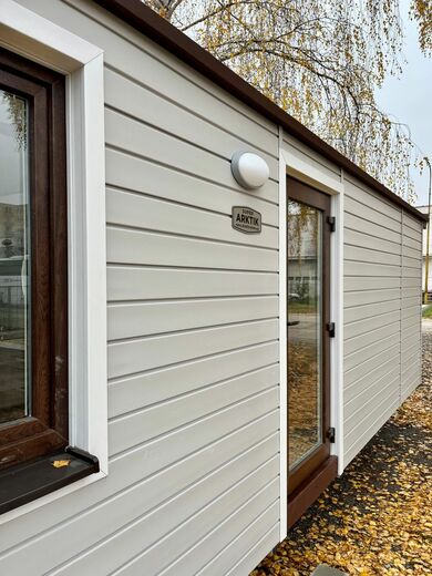 Mobile Home Exterior with Brown Windows and Doors