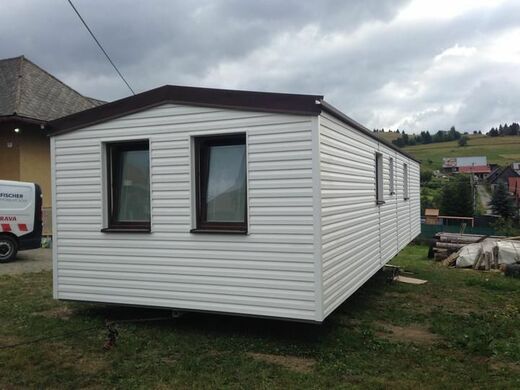 Mobile Home with White Facade and Brown Roof