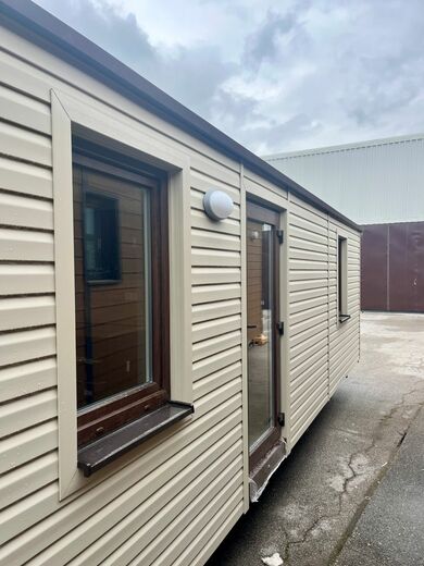Mobile Home with Beige Facade and Brown Windows