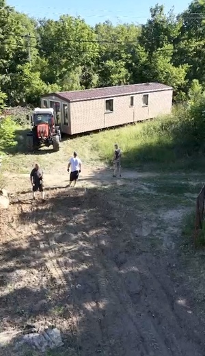 moving-mobile-home-with-tractor.jpg