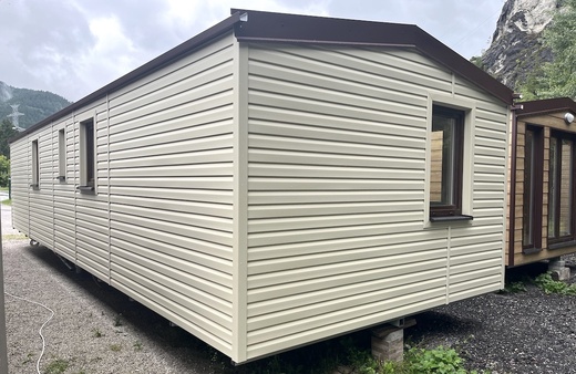 Modern White Mobile Home – Stylish Brown Roof & Windows